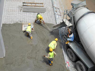 Amanco  Concrete Omaha - workers leveling wet concrete has been poured. They